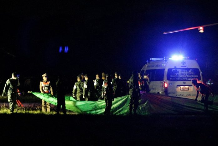 Rescued schoolboys are moved from a military helicopter to an awaiting ambulance at a military airport in Chiang Rai